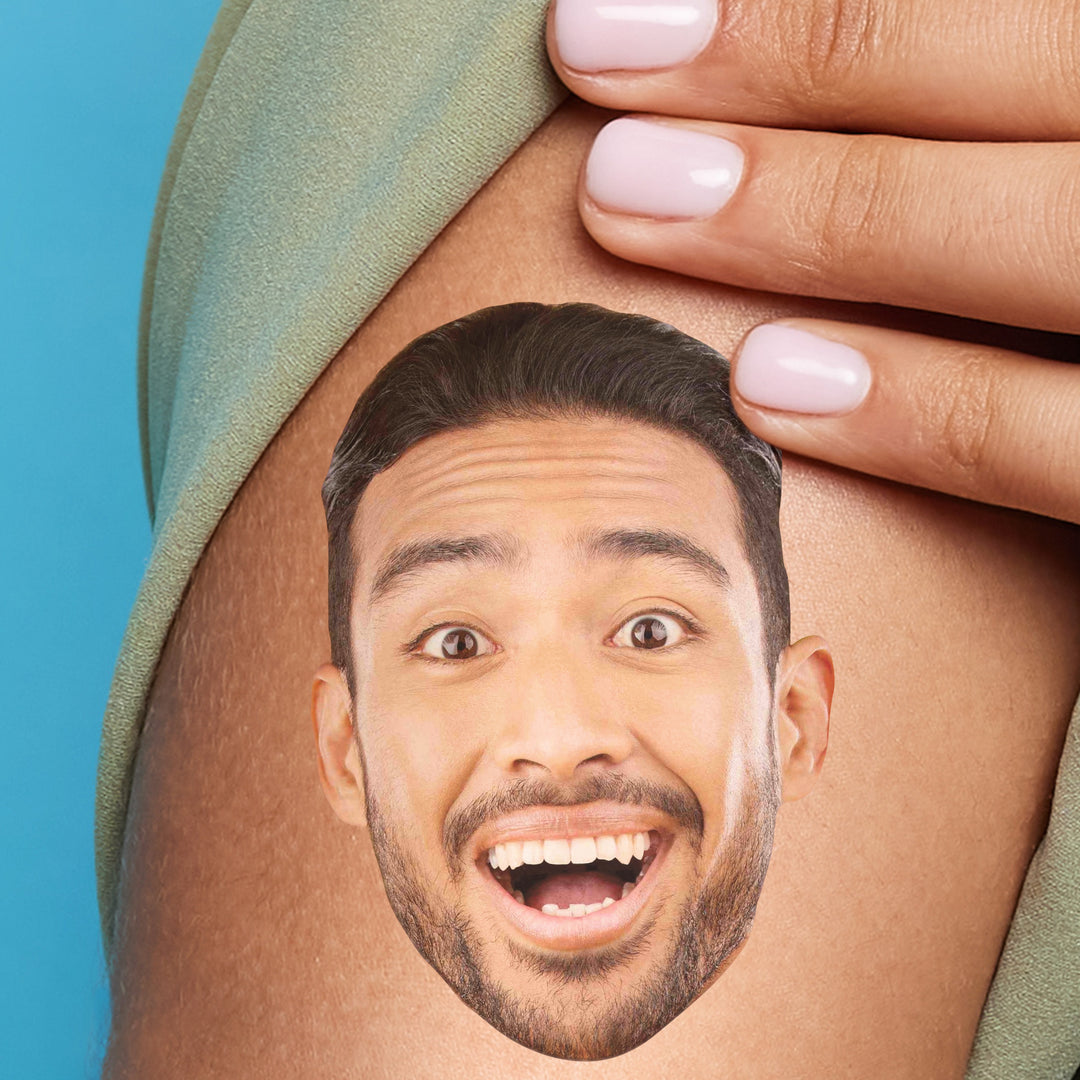 A close-up image of a person's arm with a temporary tattoo of a smiling face.