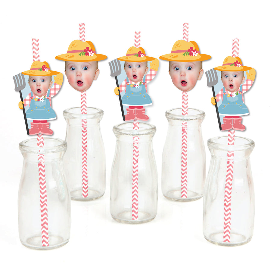 A collection of paper straw decorations with illustrated characters resembling farm animals, predominantly in pink and yellow colors, with clear striped straws and decorative elements.