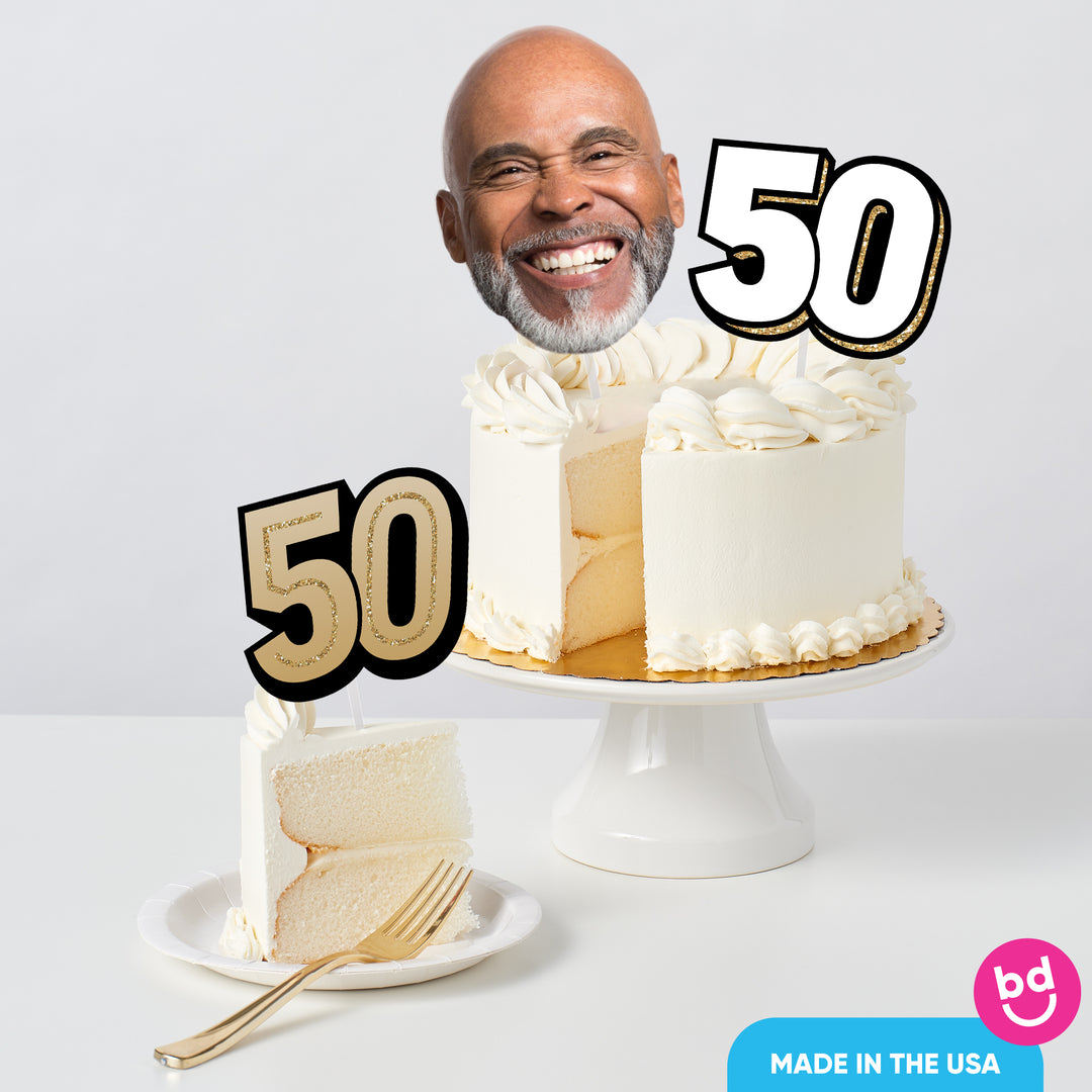 Adult 50th birthday cake decorated with black and gold toppers