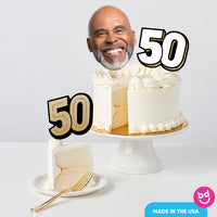 Adult 50th birthday cake decorated with black and gold toppers