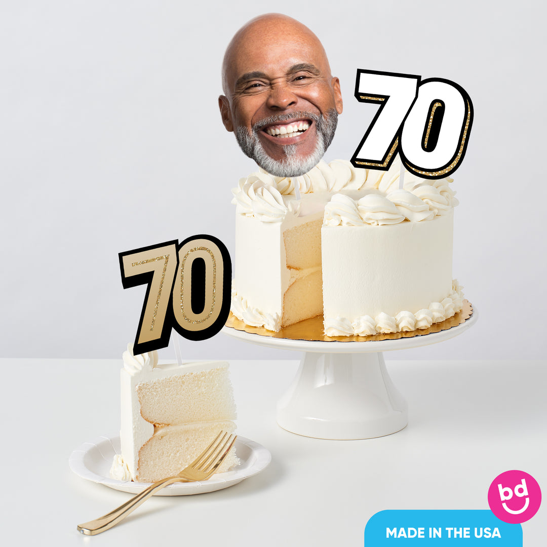 Adult 70th birthday cake decorated with gold toppers