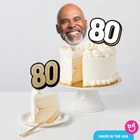 Adult 80th birthday cake styled with black and gold toppers