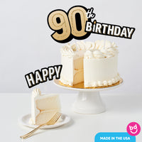 Adult 90th birthday cake decorated with gold toppers