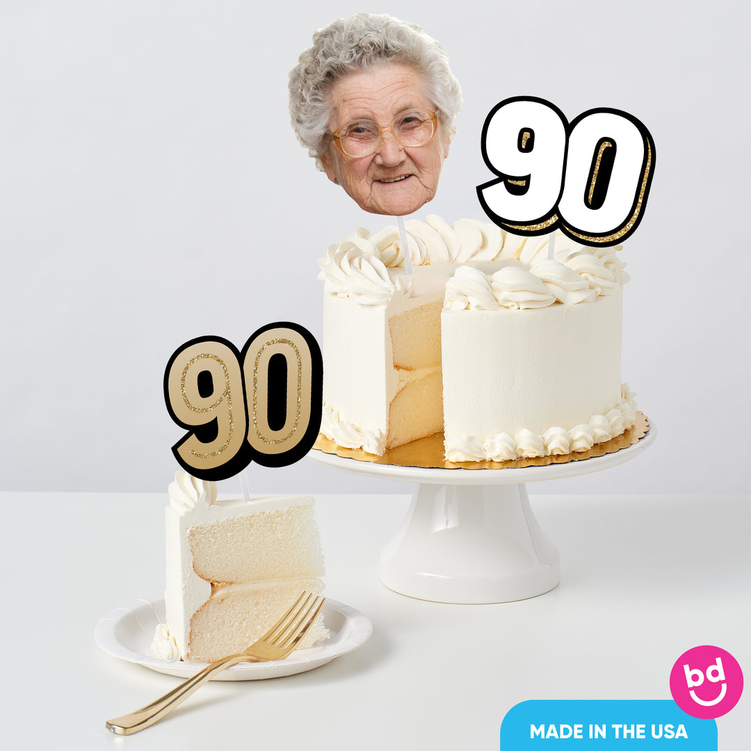 Adult 90th birthday cake decorated with gold toppers