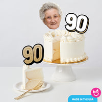 Adult 90th birthday cake decorated with gold toppers