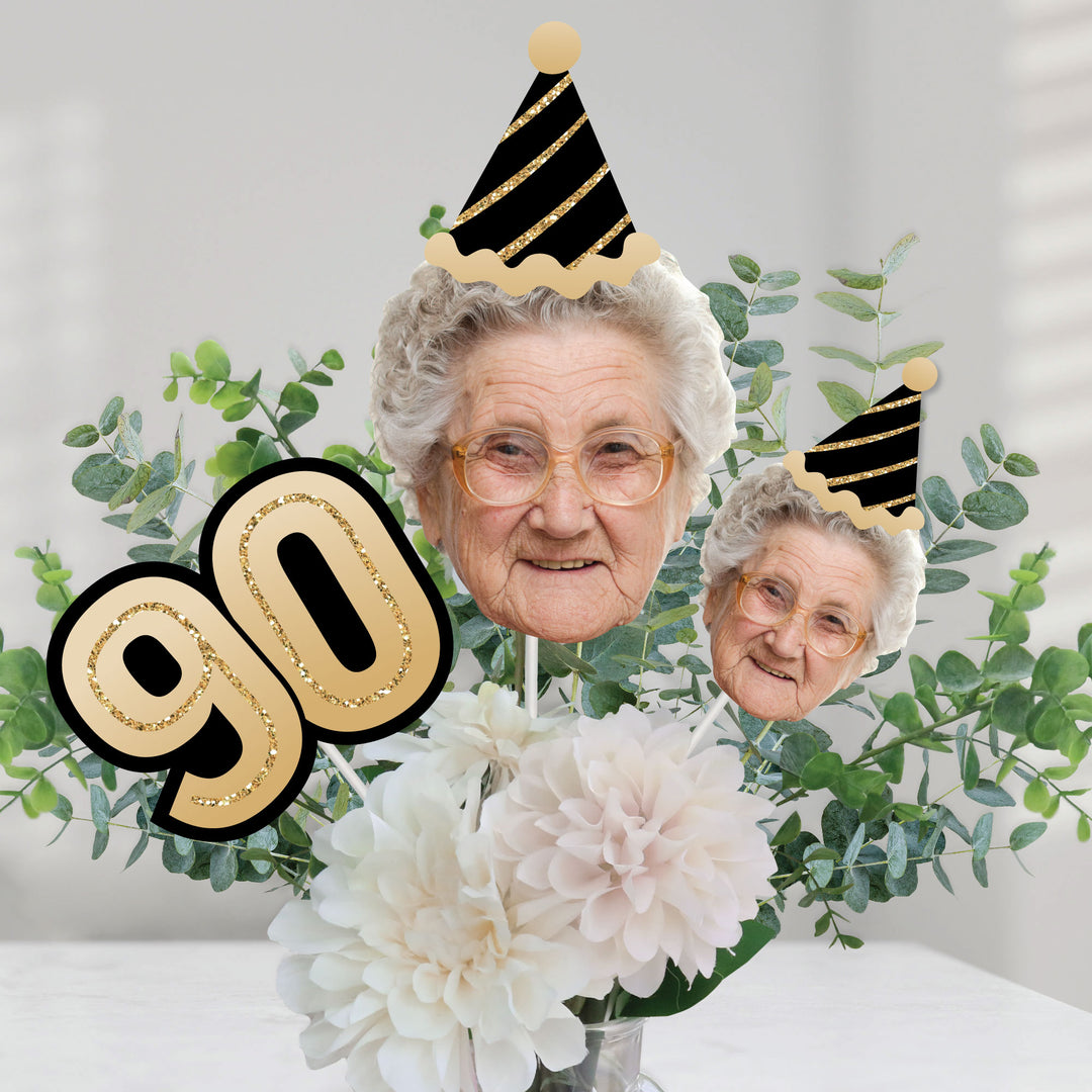 90th birthday dessert table decorated with custom face centerpieces