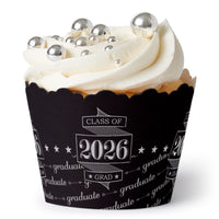Cupcake with white frosting and silver decorations, wrapped in a 'Class of 2026' themed cupcake liner.