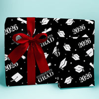 Graduation-themed gift bag with red ribbon on a light blue background