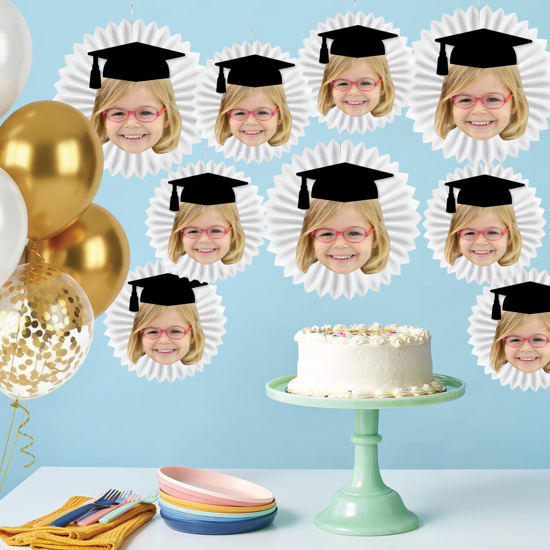 Personalized graduation paper fans styled as grad party backdrop