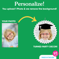 Close-up of graduate face cutout with printed graduation cap
