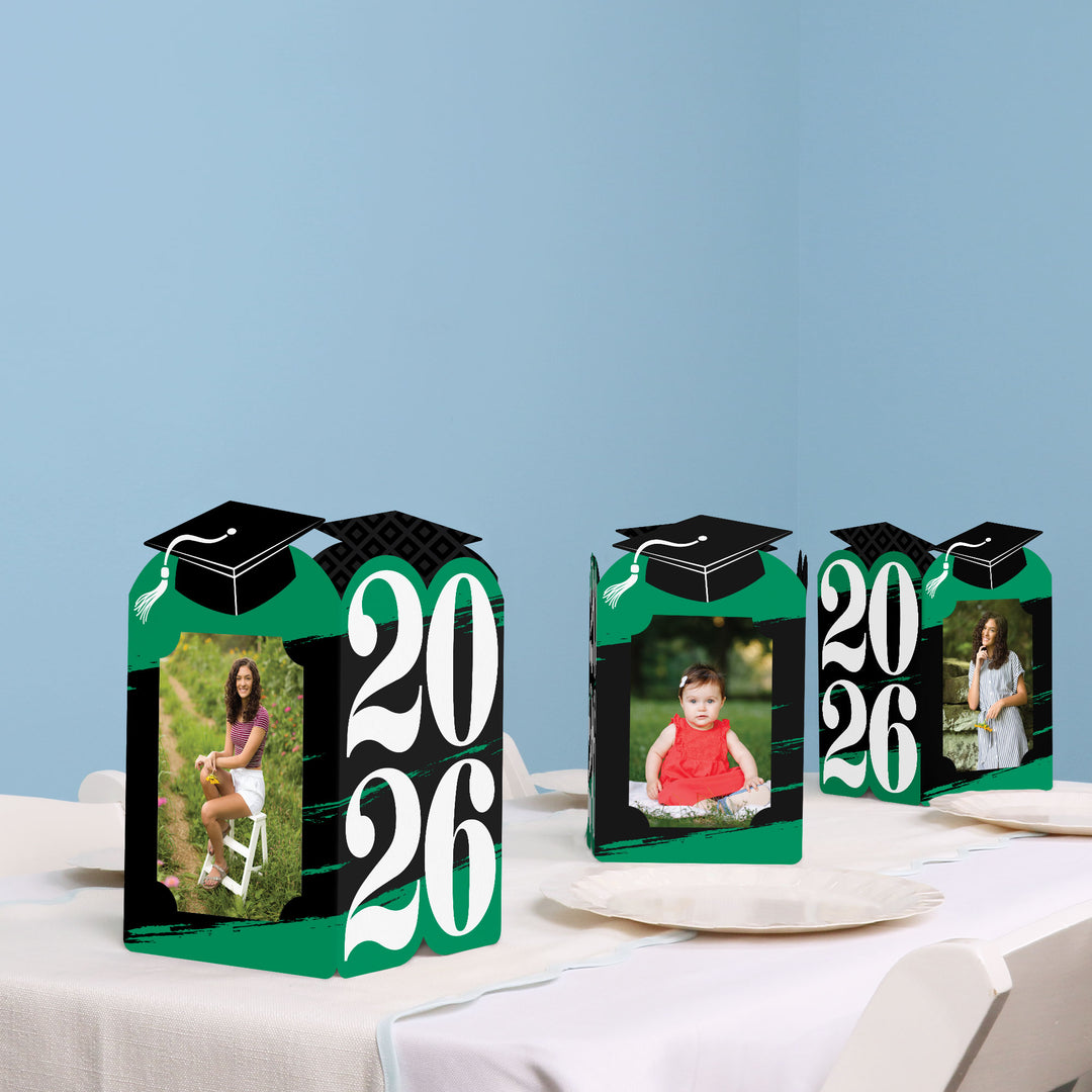 Green graduation table decor with photo centerpieces