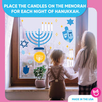 Children looking at a window with Hanukkah-themed decorations and text.