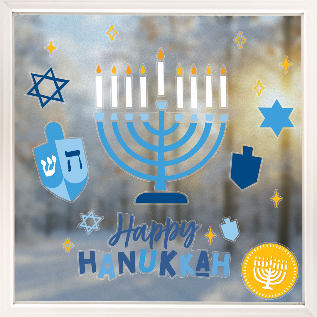 Decorative window stickers with Menorah, dreidels, and 'Happy Hanukkah' text on a glass background.