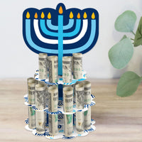 A completed Hanukkah Menorah-shaped money holder gift with rolled-up bills, featuring a blue and white color scheme and candle design.