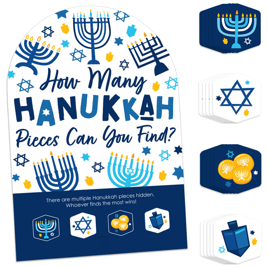 A display of a Hanukkah themed party game which includes a sign with the text 'How Many Hanukkah Pieces Can You Find?' and multiple hexagon-shaped game pieces with Hanukkah symbols and elements.