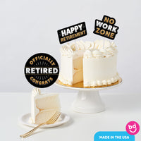 retirement party cake styled with layered topper decorations