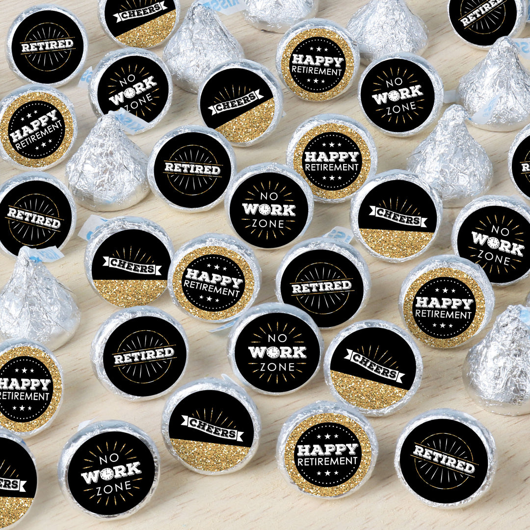 An array of round candy stickers with text celebrating retirement, displayed on a surface.