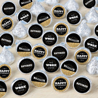 An array of round candy stickers with text celebrating retirement, displayed on a surface.