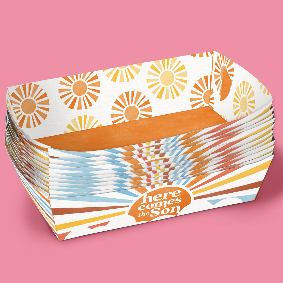 Stack of paper food trays with 'here comes the son' text 