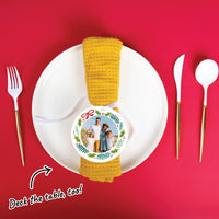 Napkin with a custom family photo ornament on a white plate with cutlery on a red background