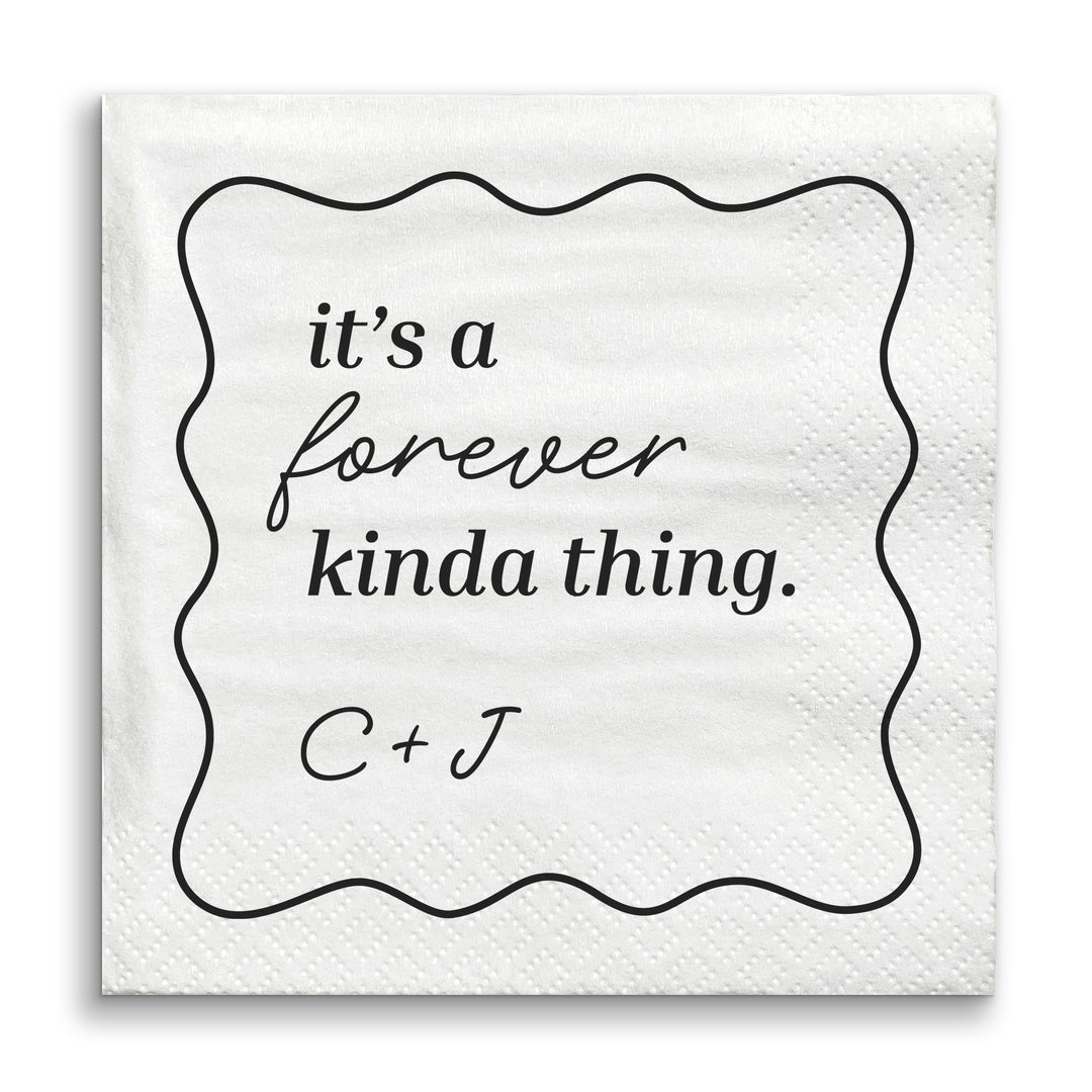 White napkin with black text 'it's a forever kinda thing. C + J' on a white background