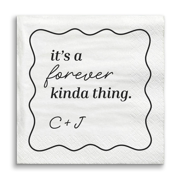 White napkin with black text 'it's a forever kinda thing. C + J' on a white background