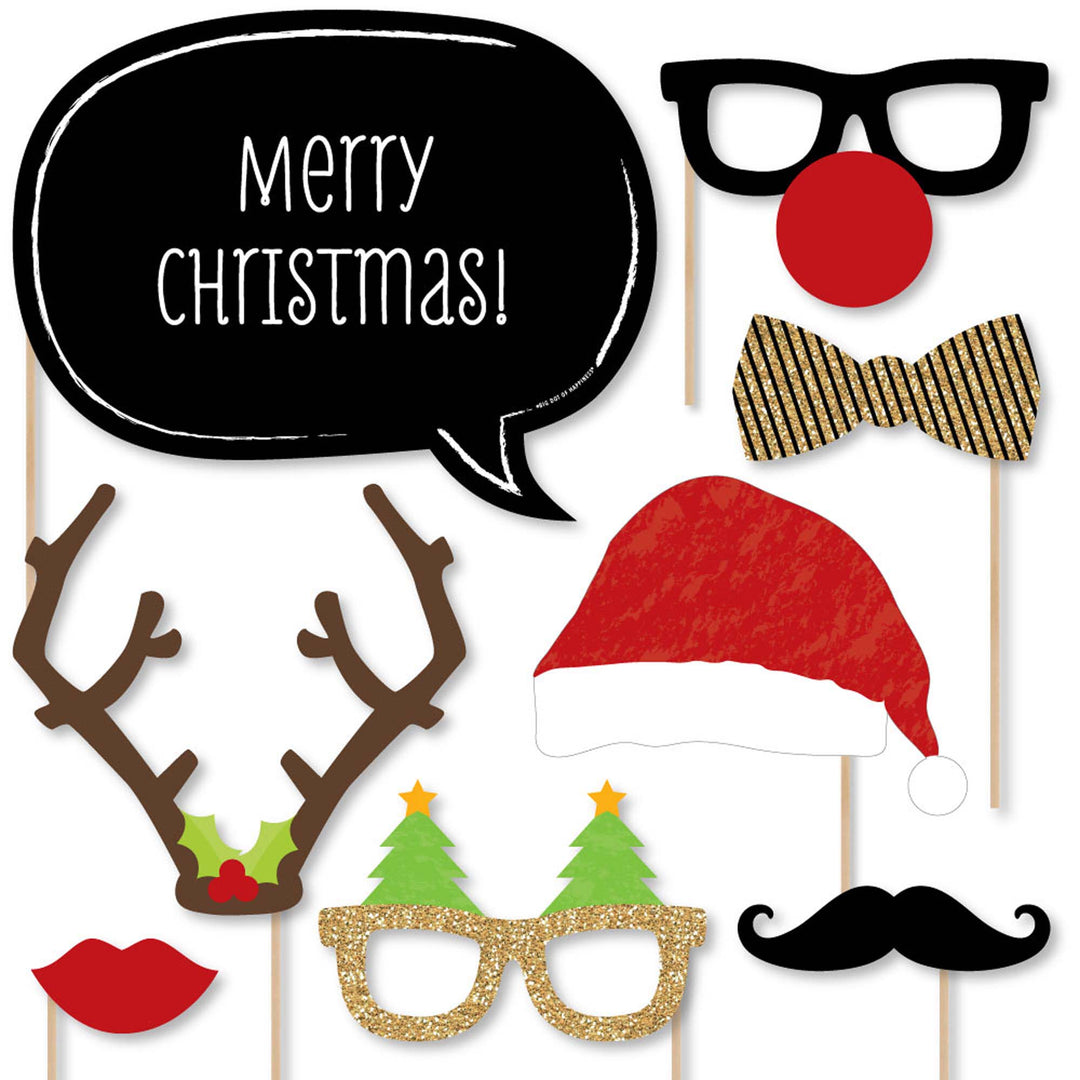 A collection of Christmas-themed photo booth props including glasses, hats, mustaches, bow ties, lips, and signs with festive messages, all on sticks for easy use.