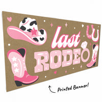 Close-up of boots, cowboy hat, and horseshoes on rodeo banner