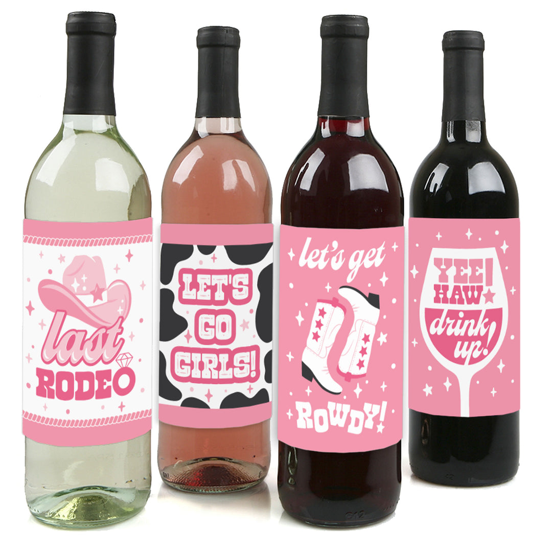 Four wine bottle label stickers with different pink designs, including text and cowgirl motifs, intended for a bachelorette party.