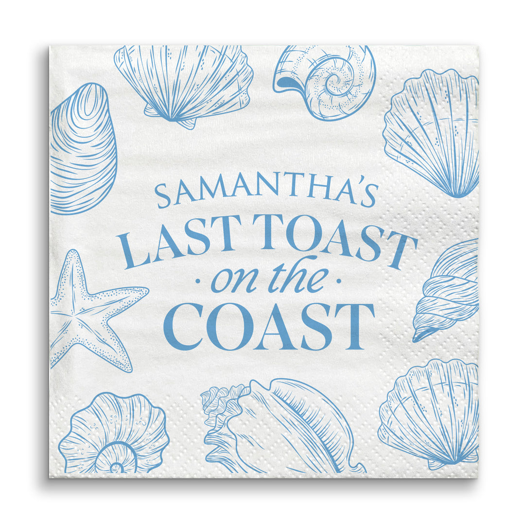 Napkin with blue shell designs and text 'Samantha's Last Toast on the Coast' on a white background