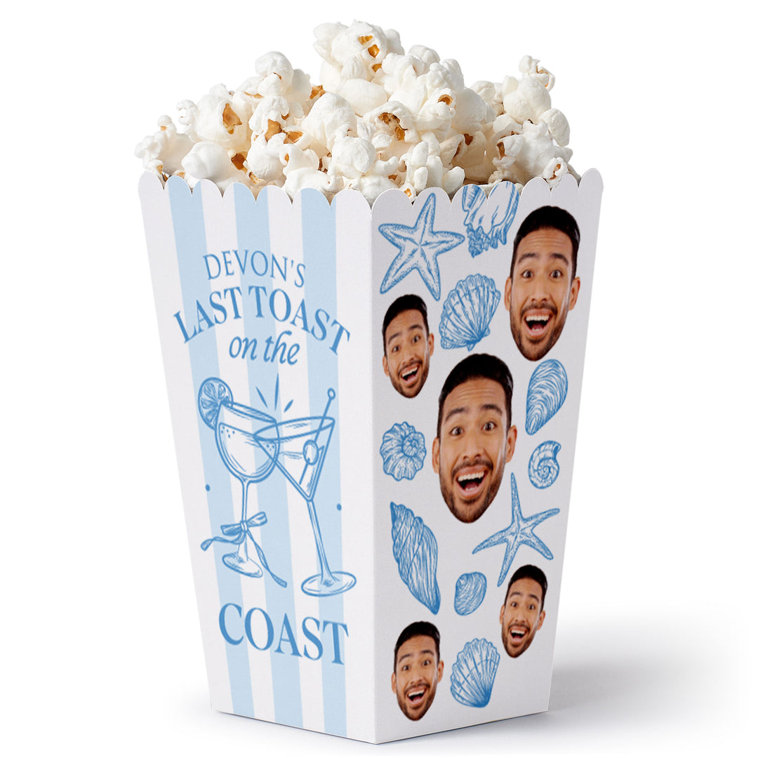 A custom printed popcorn box with a photo of a person and text that reads 'Last Toast on the Coast'. The box is decorated with illustrations of shells and a cocktail glass.