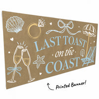 Close-up of seashells, champagne glasses, and bow on coastal banner