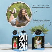 Light blue graduation party table with photo holder decor