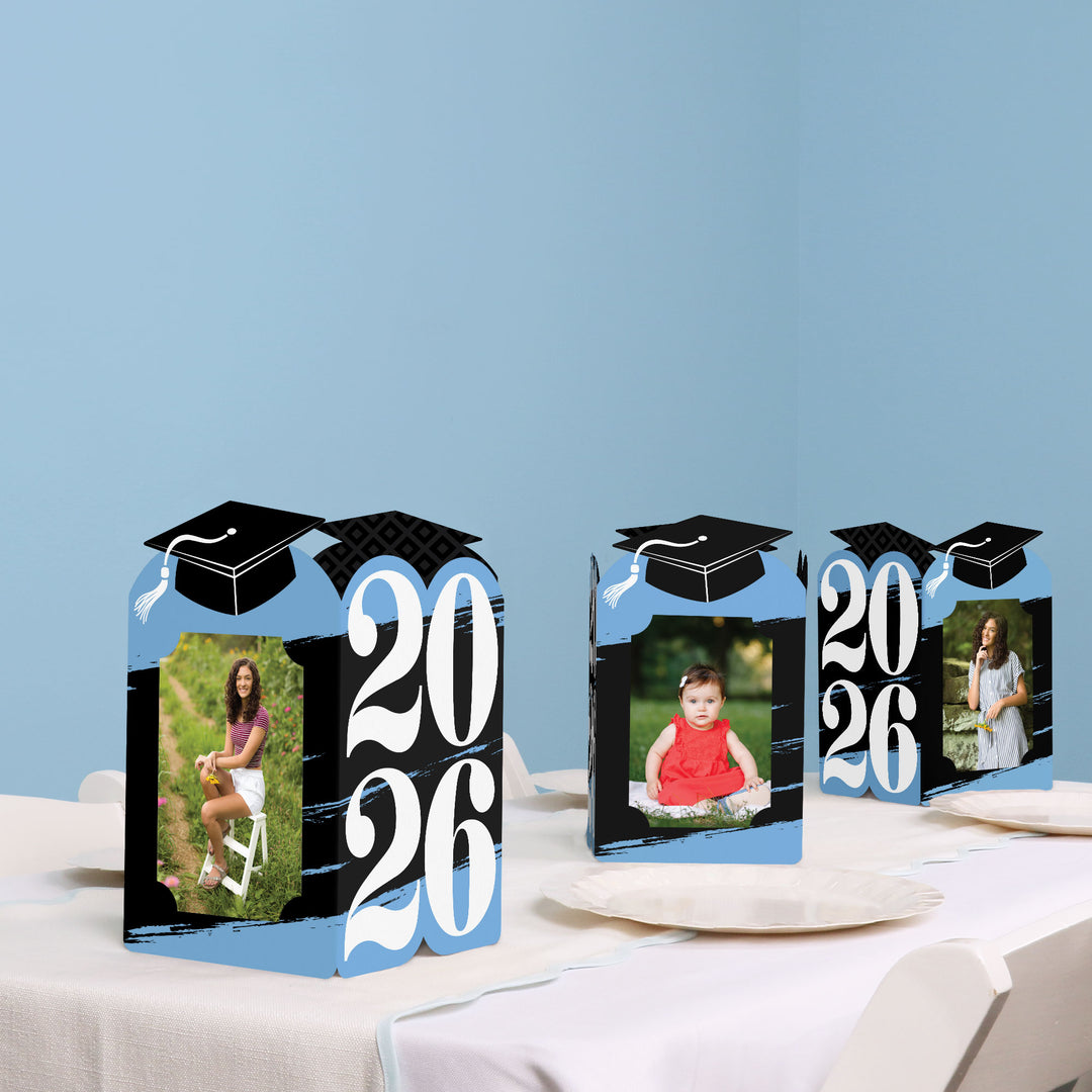Light blue graduation party table with photo holder decor