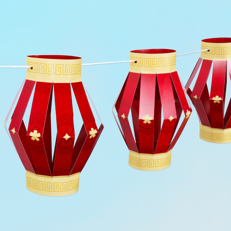 Red and gold paper lanterns for lunar new year 2026 on a blue background