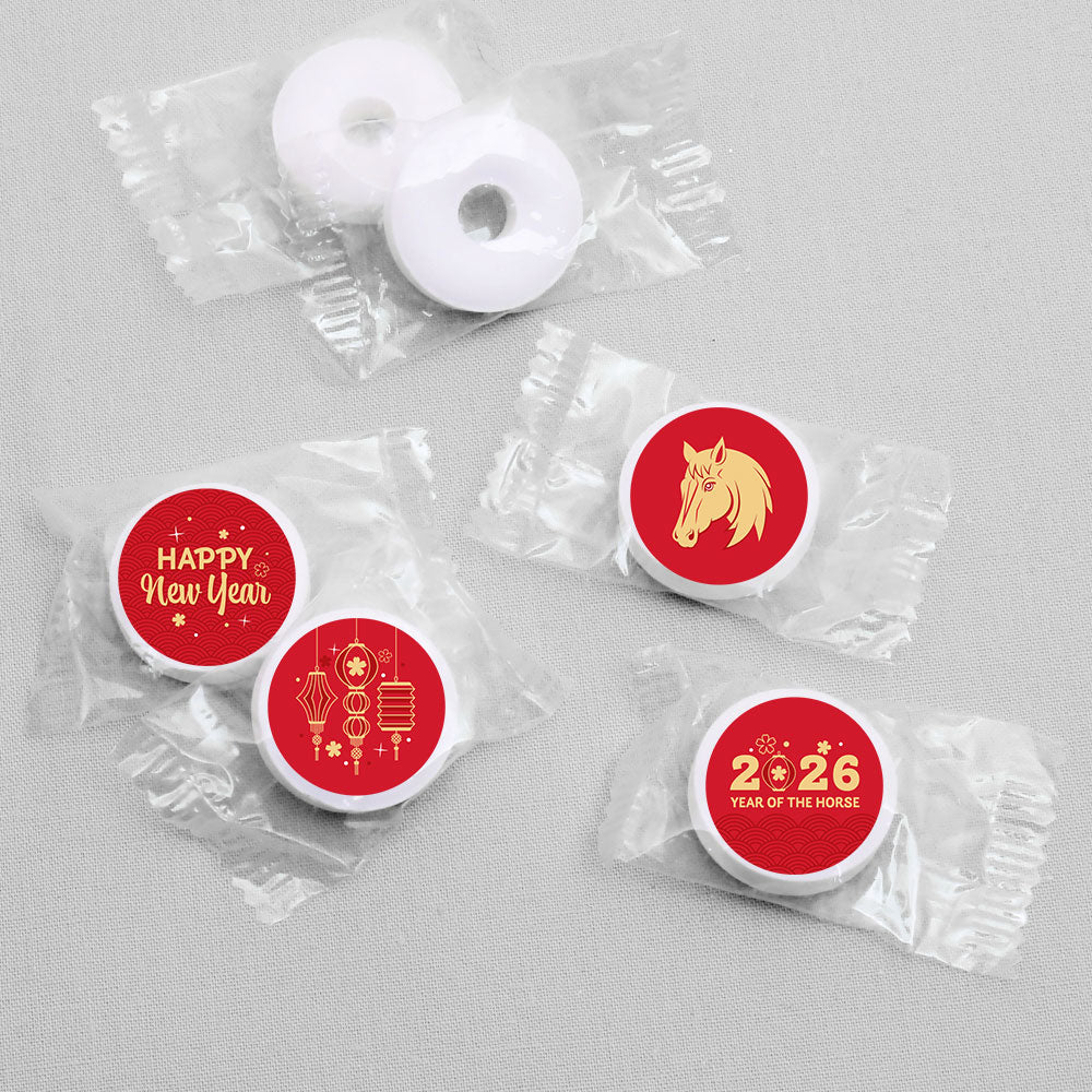 Small round candies featuring New Year's designs on a gray background