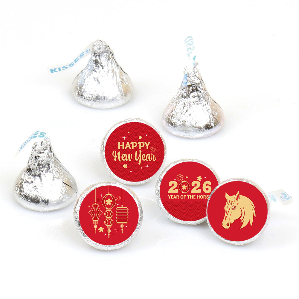 Hershey's Kisses with red New Year's stickers on a white background