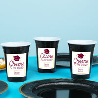 Maroon personalized graduation cups on party table