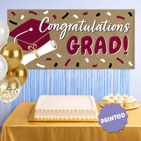 Maroon graduation banner hanging at party