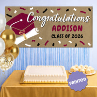 Maroon graduation banner displayed at party