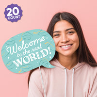 Woman holding a 'Welcome to the real world!' sign against a pink background