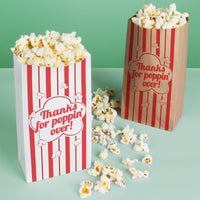Two popcorn bags with 'Thanks for poppin' over!' text on a green background