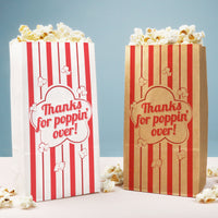 Two popcorn bags with red and white stripes and 'Thanks for poppin' over!' text on a light blue background.