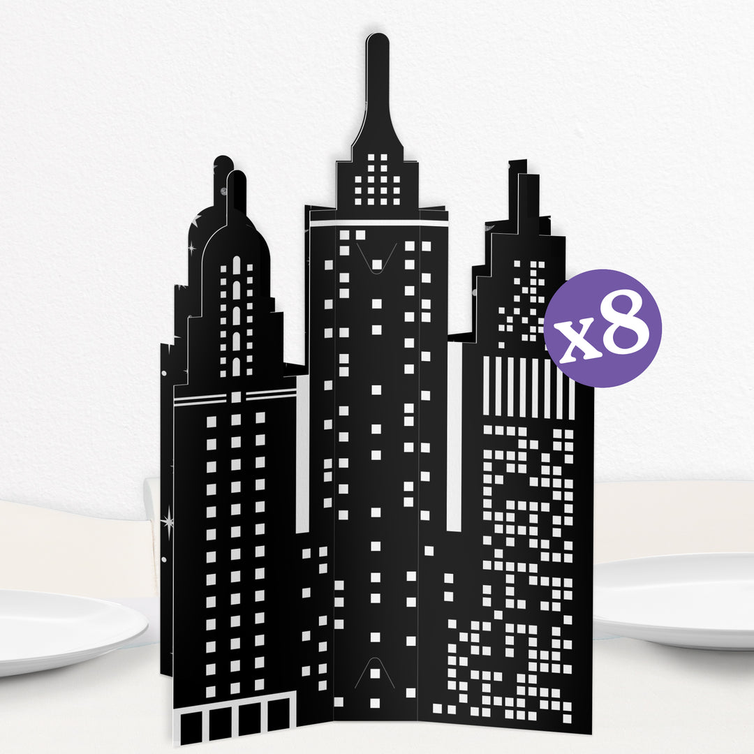 A set of 8 black and white 3D city skyline table centerpieces made from cardstock.