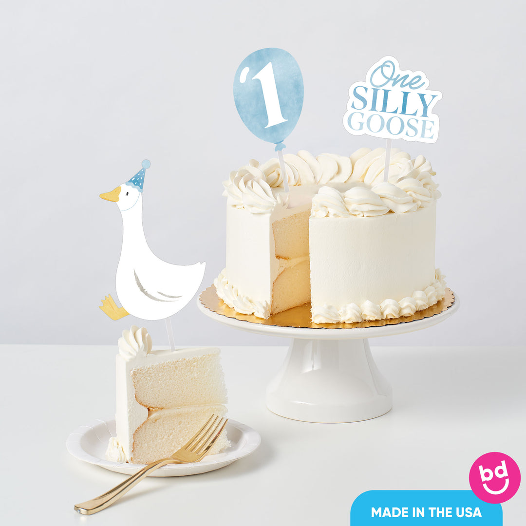 baby boy first birthday cake with goose toppers