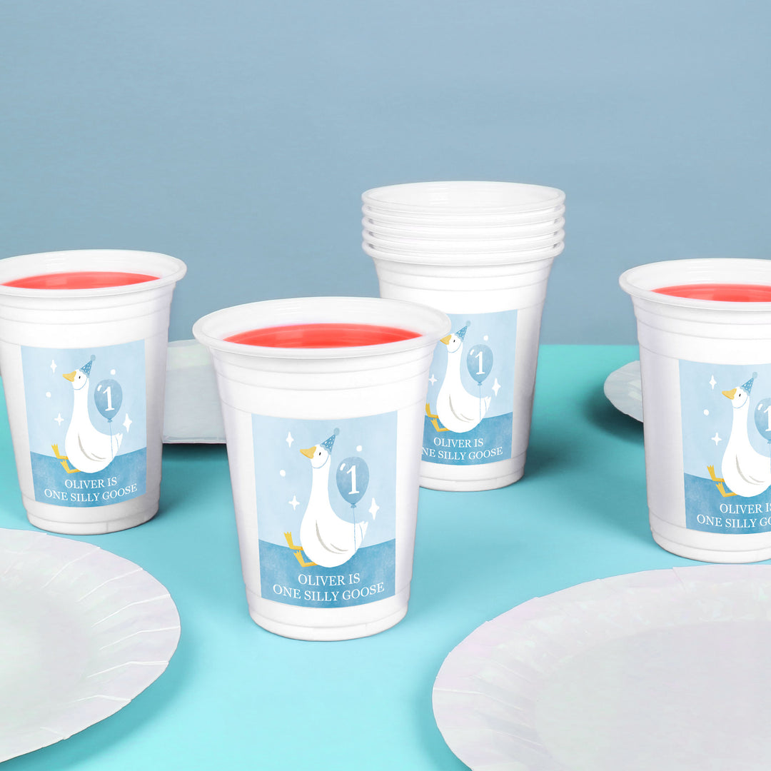 Boy’s first birthday party table with silly goose custom cups