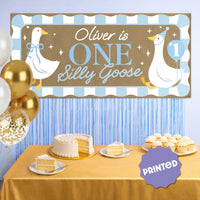 Blue first birthday party backdrop with goose banner