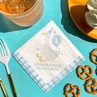Boy’s first birthday table styled with silly goose napkins