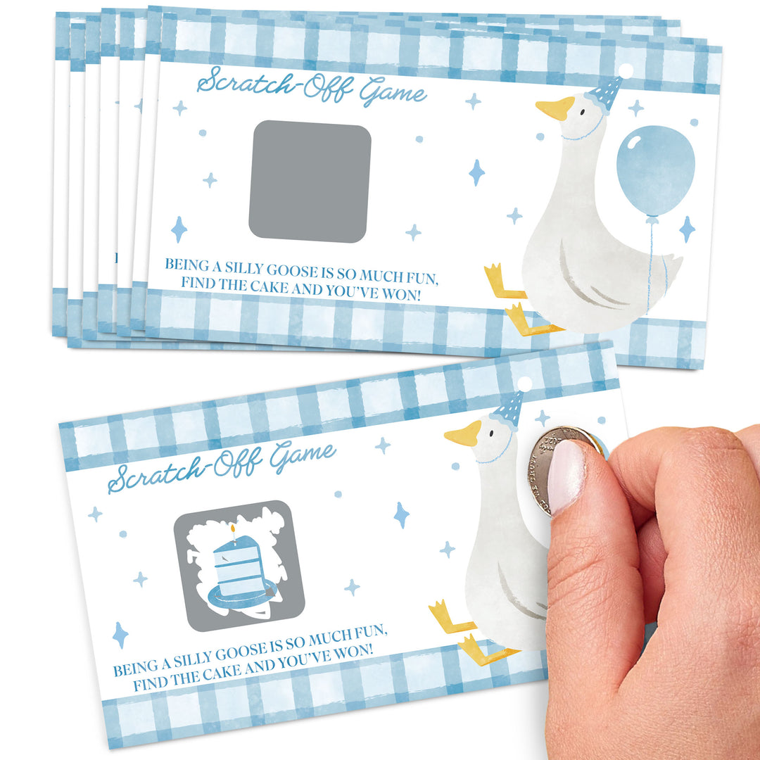 Scratch-off game cards with a goose design and a hand scratching one of them.