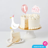 baby girl first birthday cake with goose toppers